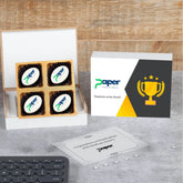 Open wooden box with logo‑printed chocolates and message packet