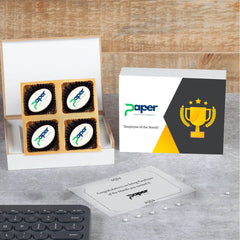 Open wooden box with logo‑printed chocolates and message packet