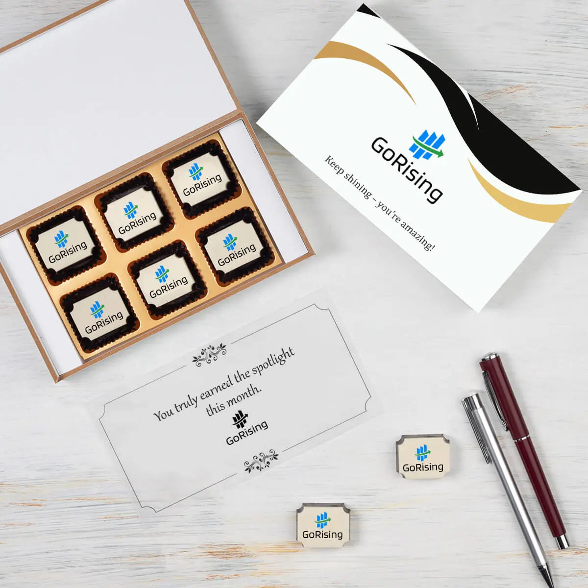 Open  wooden gift box with ‘Employee of the Month’ chocolates inside