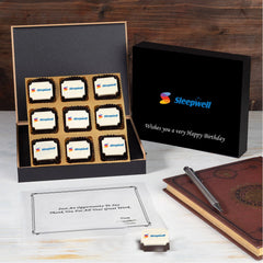 Open 9‑chocolate box featuring logo‑printed selection