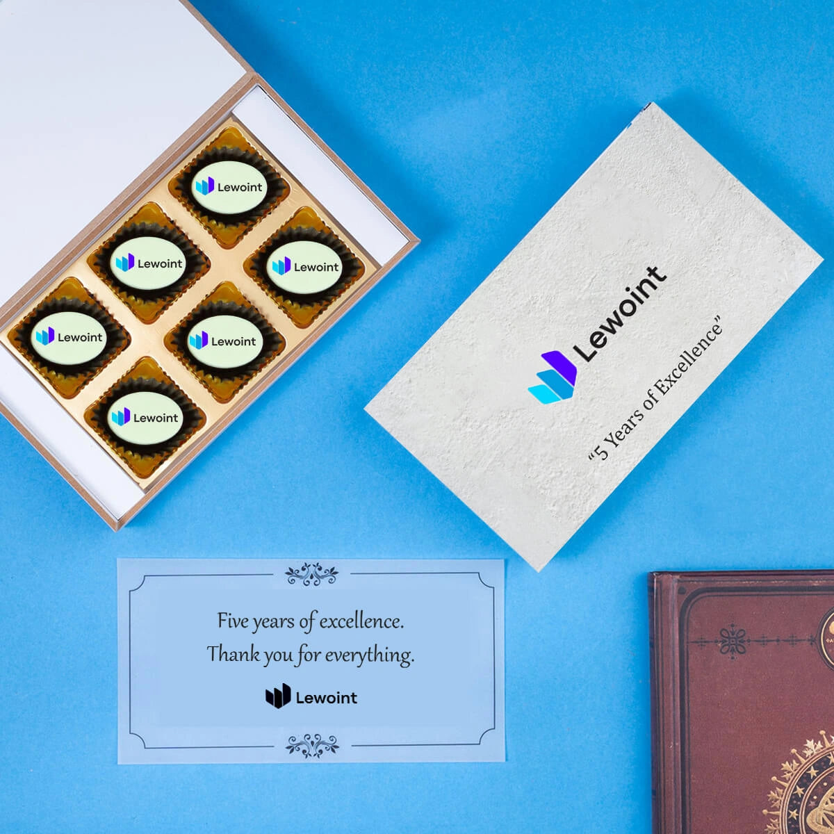Open gift box with mix of logo chocolates and blank spaces for customization