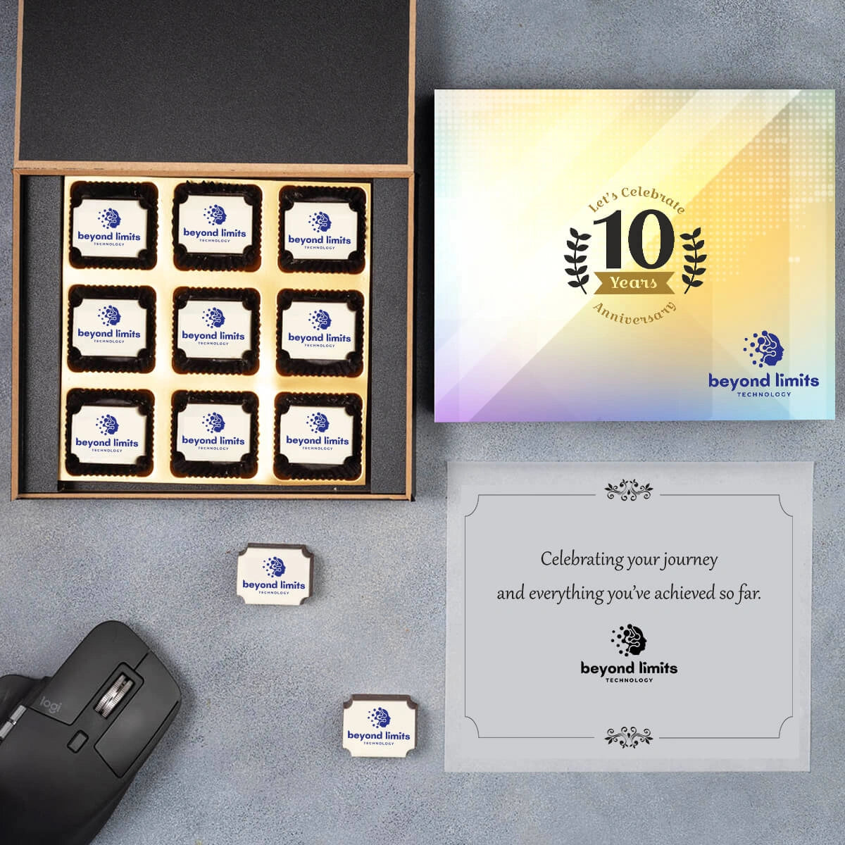 Large wooden box showcasing nine printed logo chocolates and thoughtful note inside