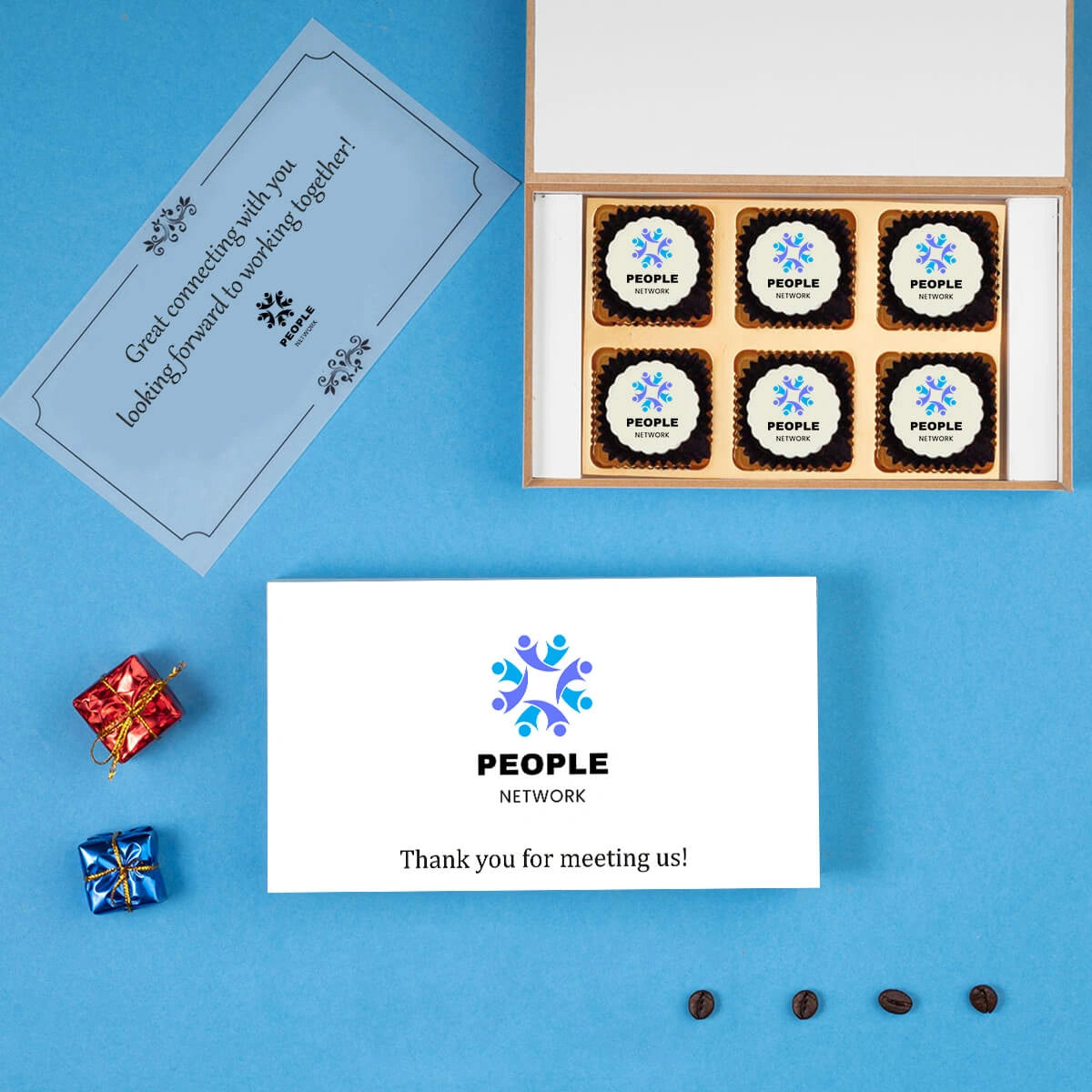 Open gift box with nine custom-branded chocolates and “Thank You” note