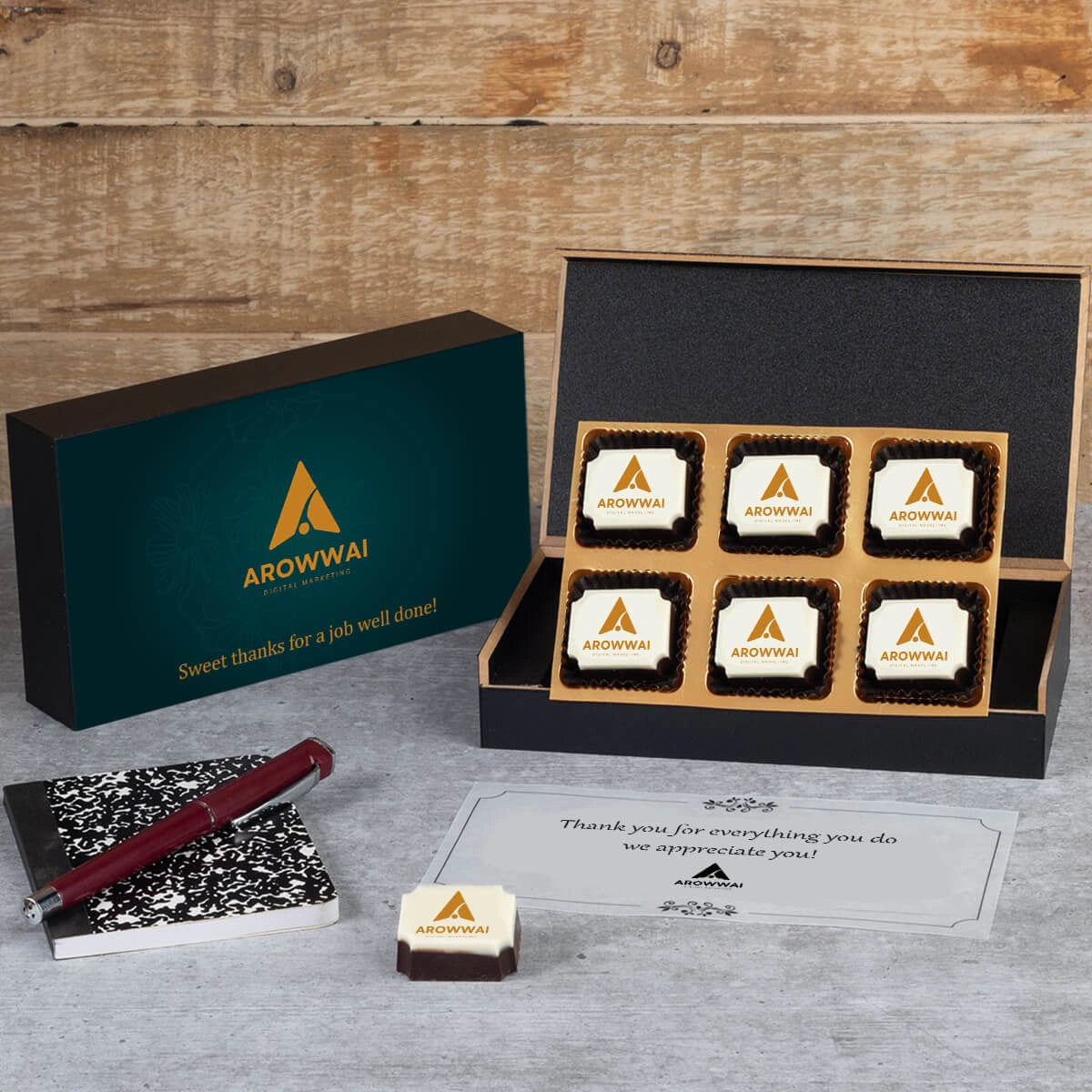 Wooden box open to reveal logo chocolate assortment