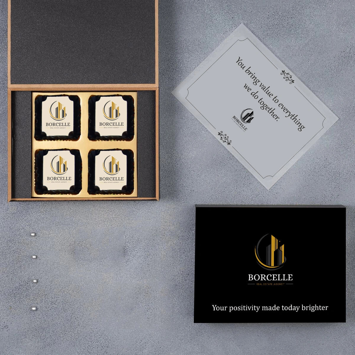 Closed wooden box with embossed logo and peek of chocolates