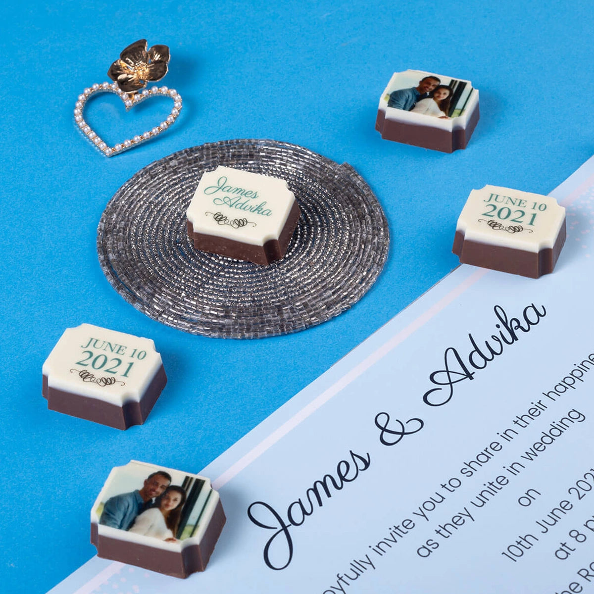 Close-up of chocolates printed with custom photo designs for wedding invitations
