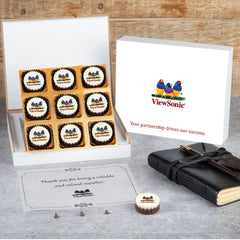 Flat‑lay arrangement featuring logo chocolate discs and box for branding display