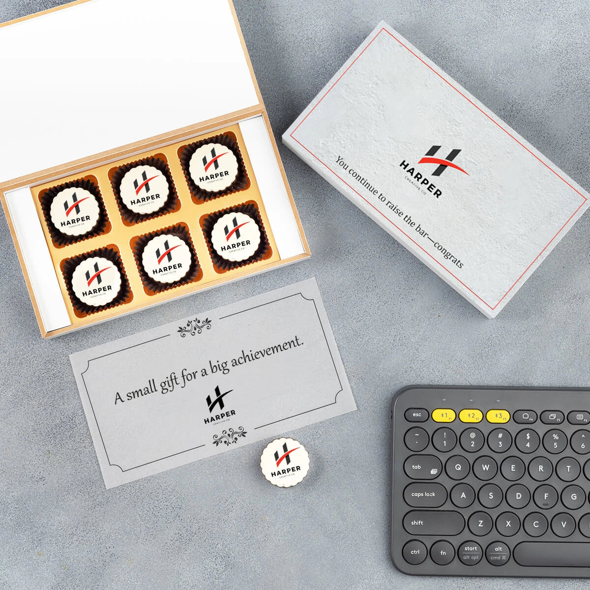 Branded wooden box lid open showcasing logo chocolate pieces