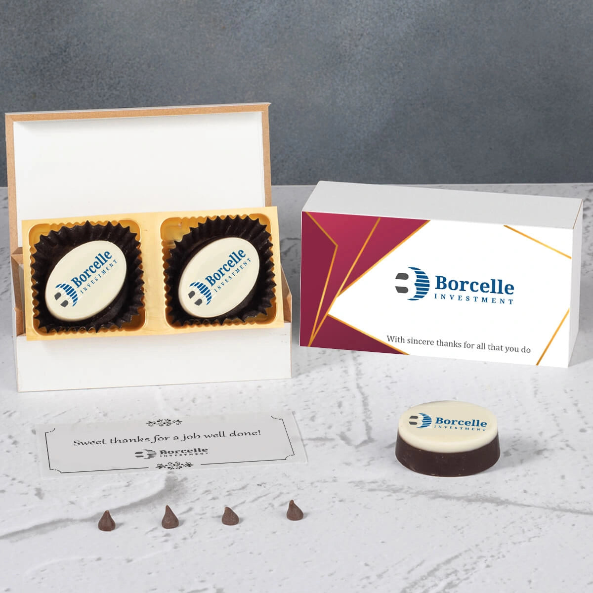 Open corporate gift box with logo‑printed chocolates