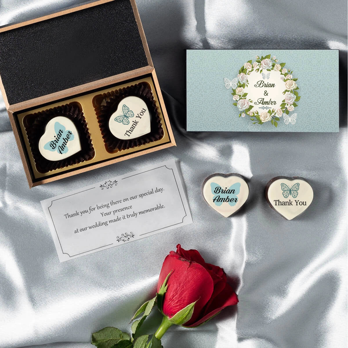 Black wooden wedding favor box holding two custom printed chocolates
