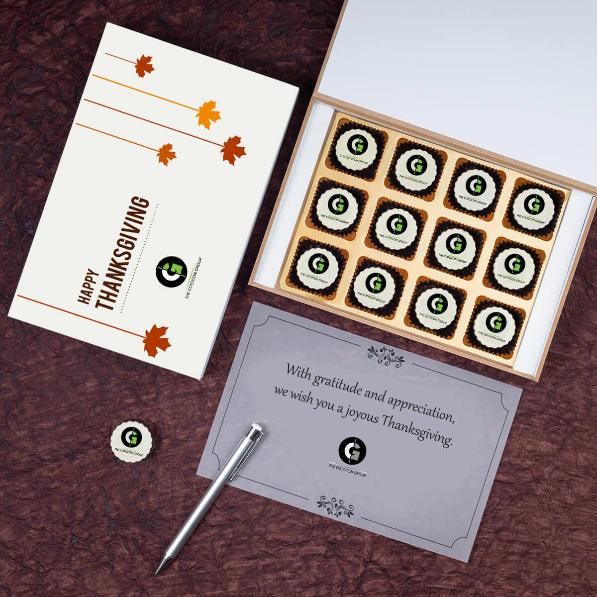 Open view of 12 luxury chocolates with edible logos, ideal for Thanksgiving client appreciation